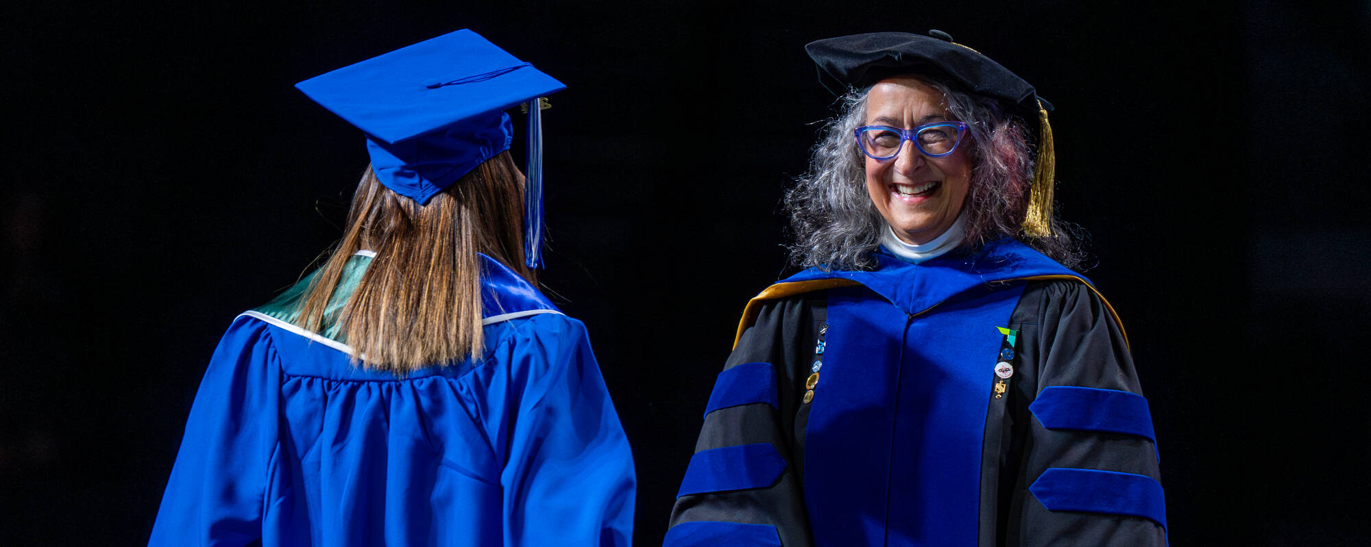 Diana R. Lawson, dean of the Seidman College of Business, congratulates graduates during Commencement at Van Andel Arena December 7.
